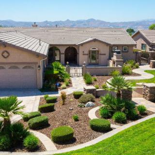 Beautifully landscaped suburban home with desert-style garden.