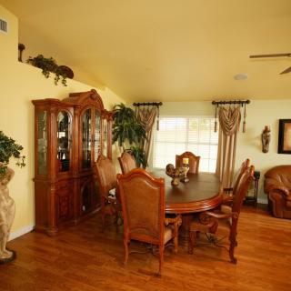 A cozy dining room with classic wooden furniture and elegant decor.