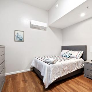 A modern, minimalist bedroom with a comfortable bed and sleek furniture.