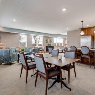 A modern dining area with elegant furnishings and ample seating.