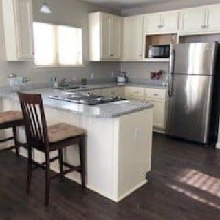 A modern kitchen with a central island and stainless steel appliances.