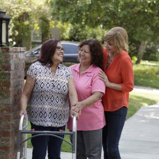A heartwarming moment of support and connection among three women outdoors.