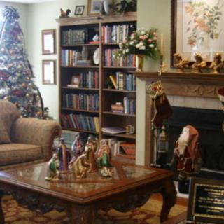 A cozy living room decorated for Christmas with a nativity scene on the coffee table.