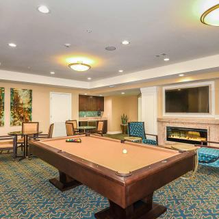 A modern game room featuring a billiard table and comfortable seating.