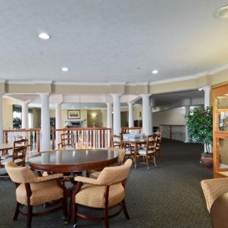 A spacious lobby area with elegant furniture and warm lighting.