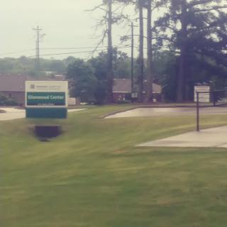 A view of a roadside sign indicating a nearby business.
