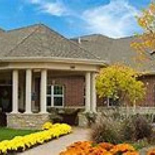 A beautiful house with a well-maintained garden and vibrant flowers.