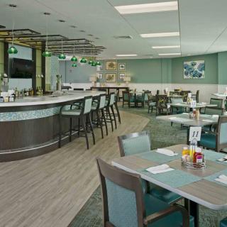 Modern restaurant interior with bar and seating area.