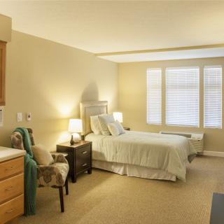 A cozy bedroom with natural lighting and elegant furnishings.