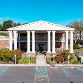 A beautiful building with classic architecture featuring prominent columns and a welcoming entrance.