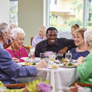 A diverse group of people enjoying a meal together at a restaurant.