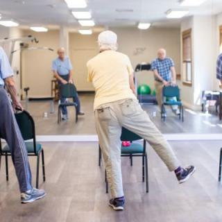 A group of seniors participating in a fitness class focusing on balance exercises.