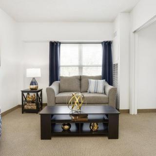A cozy living room with a sofa, coffee table, and stylish decor.