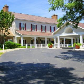 A large building with a welcoming entrance and surrounding greenery.