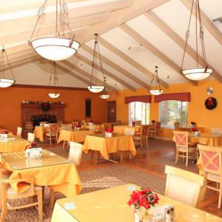 A warmly decorated dining area with tables set for guests.