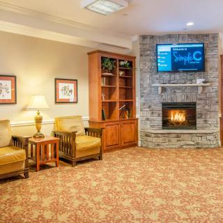 A cozy living room featuring a fireplace, television, and comfortable seating.