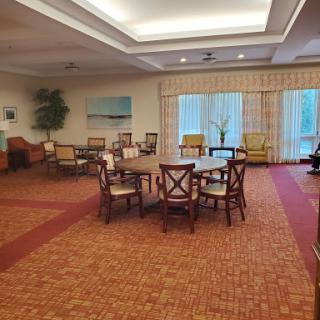 A spacious and inviting seating area with comfortable chairs and natural light filtering through large windows.