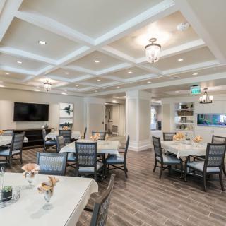 A spacious and elegantly designed dining area with modern furniture and lighting.