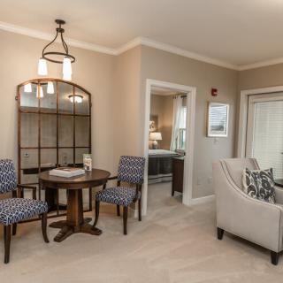 A cozy living and dining area with elegant furniture and neutral tones.
