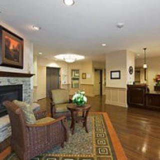 A cozy lobby with seating and a fireplace.