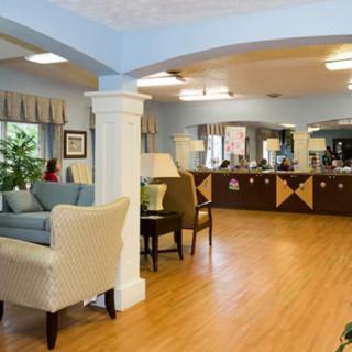 A modern lobby area with comfortable seating and a reception desk.