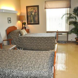 A cozy hotel room featuring two beds, elegant decor, and natural light.