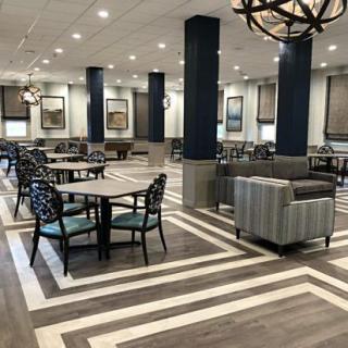 A spacious and modern dining area with stylish seating and elegant lighting.