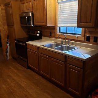 A cozy kitchen with wooden cabinets and stainless steel appliances.