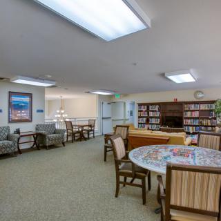 A cozy library with seating areas and bookshelves filled with books.