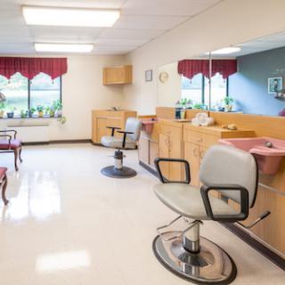 A well-lit and organized hair salon featuring barber chairs and wooden furnishings.