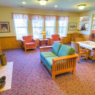 A cozy living room with comfortable seating and large windows.