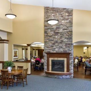 A cozy and spacious lobby with a stone fireplace and seating area.