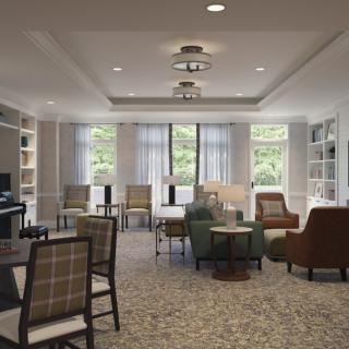 A modern living room with comfortable seating and bookshelves.
