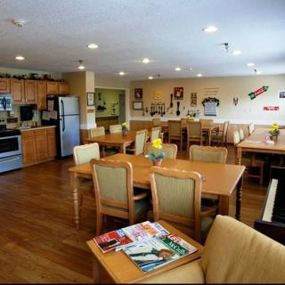 A spacious community kitchen and dining area with modern appliances and cozy furnishings.