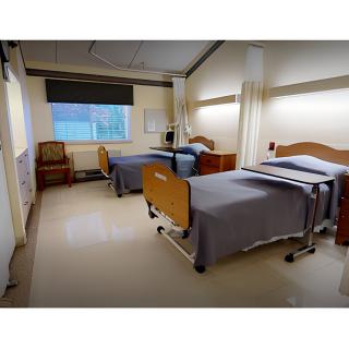 A clean and organized hospital room with two beds, ready for patients.