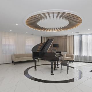 A modern and luxurious living room featuring a grand piano with elegant wooden ceiling decor.