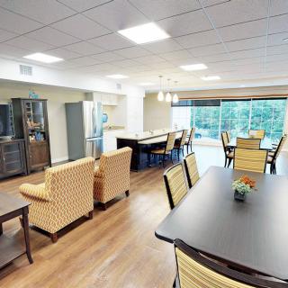 A spacious and well-lit living area with comfortable seating and large windows.