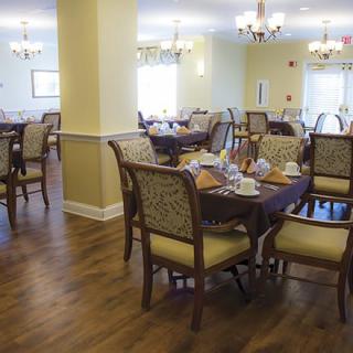 A cozy dining room with elegant furniture and warm lighting.