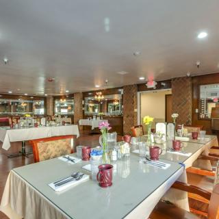 An elegantly decorated restaurant dining area with neatly arranged tables and chairs.