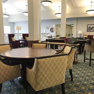 A spacious dining area with elegant furniture and soft lighting.