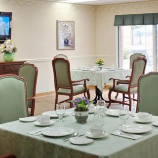 An elegant dining room with a neatly set table and classic decor.