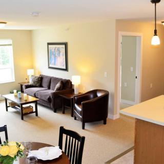 A cozy living and dining area with modern furniture and decor.