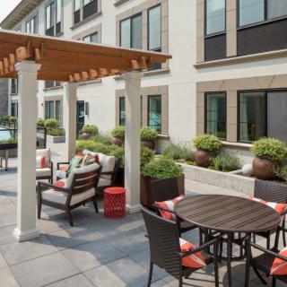 Modern patio area with comfortable seating and a pergola.