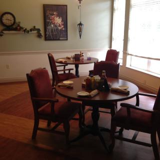 Cozy dining area with tables and chairs set up, ready for guests.
