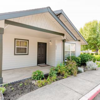 A charming house entrance with a small garden and porch area.