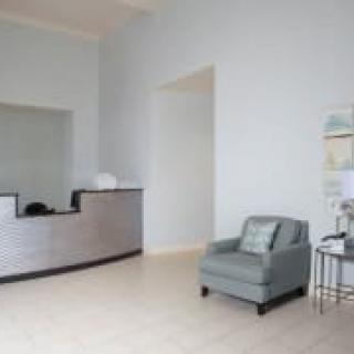 A minimalist reception area with a desk and seating.