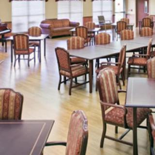 A spacious dining area with multiple tables and chairs arranged neatly.