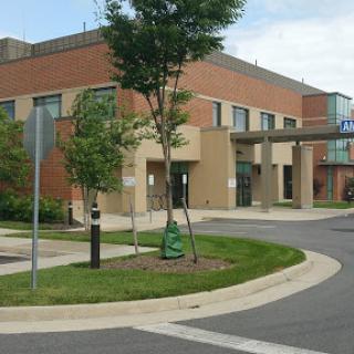 A modern medical facility surrounded by greenery.