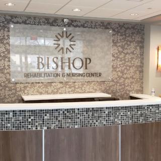 Reception area of Bishop Senior Living and Nursing Center featuring modern decor and signage.