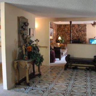 A vintage-style living room with elegant furnishings and floral decorations.